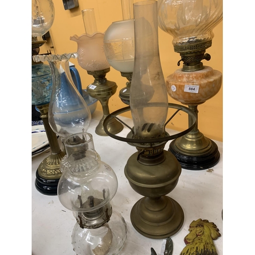 883 - THREE VINTAGE OIL LAMPS, ONE BRASS AND TWO GLASS