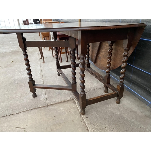 2744 - AN EARLY 20TH CENTURY OAK GATE LEG DINING TABLE ON BARLEY TWIST LEGS