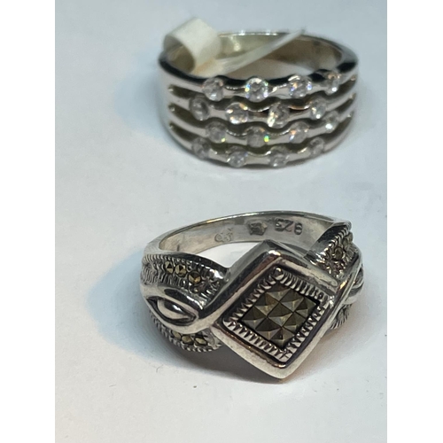 699 - FOUR VARIOUS SILVER RINGS WITH CLEAR STONES