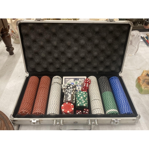 169 - A POKER SET WITH POKER CHIPS, CARDS AND DICE IN AN ALUMINIUM CASE