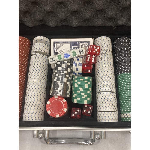 169 - A POKER SET WITH POKER CHIPS, CARDS AND DICE IN AN ALUMINIUM CASE