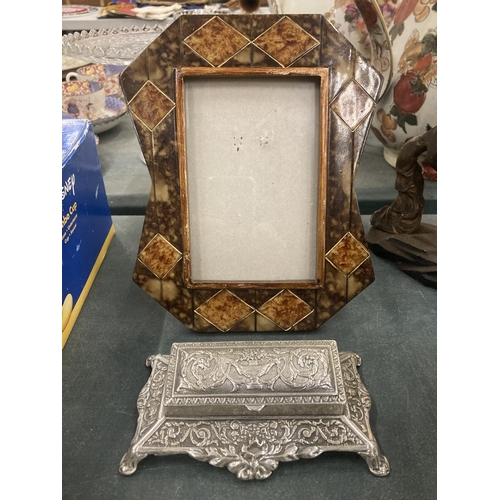 195 - AN ORNATE PHOTO FRAME AND A SILVER PLATED STAMP HOLDER