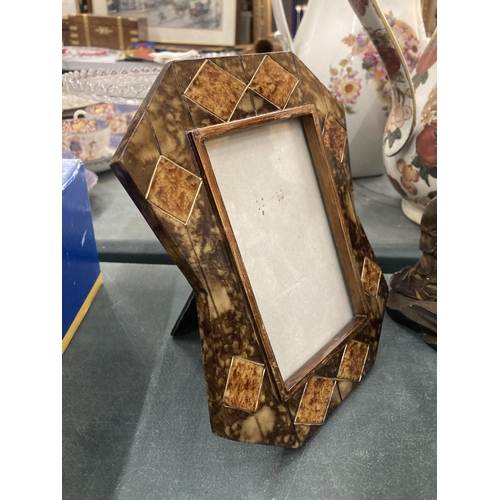 195 - AN ORNATE PHOTO FRAME AND A SILVER PLATED STAMP HOLDER