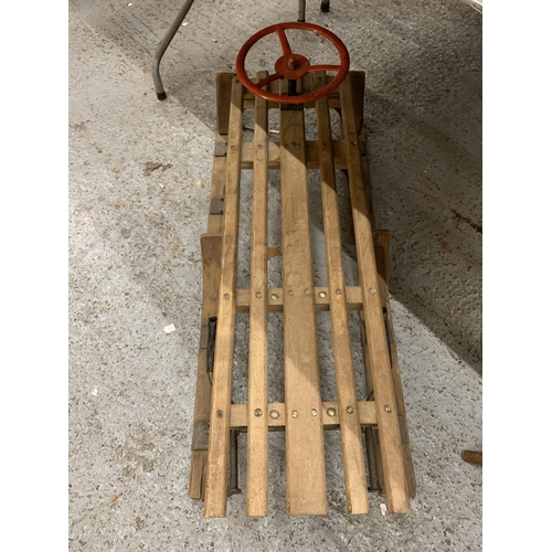 255 - A VINTAGE WOODEN SLEDGE WITH A STEERING WHEEL