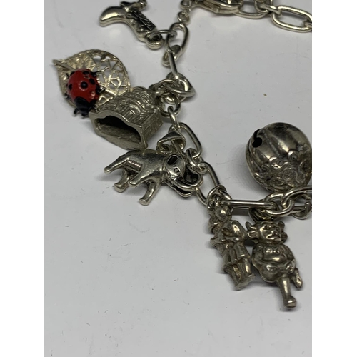 592 - A SILVER CHARM BRACELET WITH FOURTEEN CHARMS