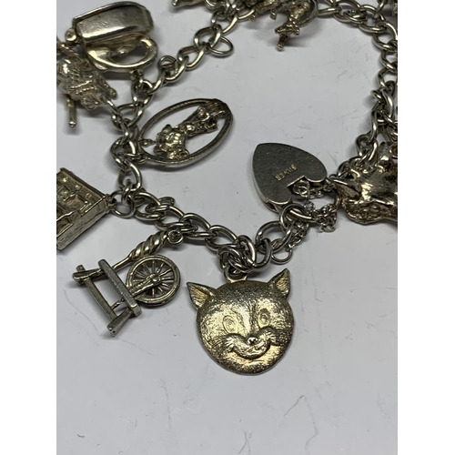 627 - A SILVER BRACELET WITH THIRTEEN CHARMS