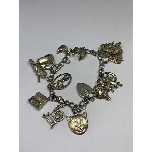 627 - A SILVER BRACELET WITH THIRTEEN CHARMS