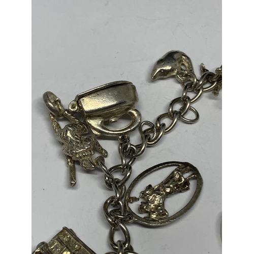 627 - A SILVER BRACELET WITH THIRTEEN CHARMS