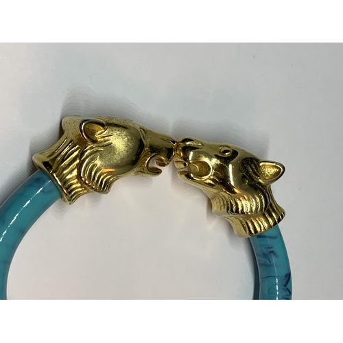 684 - AN ORNATE ANIMAL HEAD BANGLE