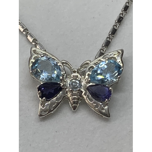 539 - A SILVER NECKLACE WITH A BUTTERFLY AND BLUE STONE PENDANT IN A PRESENTATION BOX