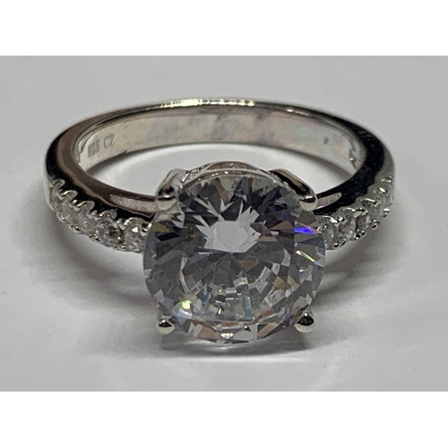 551 - A SILVER RING WITH CUBIC ZIRCONIAS IN A PRESENTATION BOX