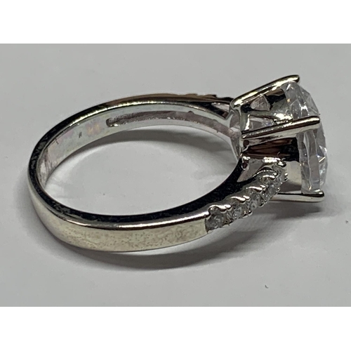 551 - A SILVER RING WITH CUBIC ZIRCONIAS IN A PRESENTATION BOX