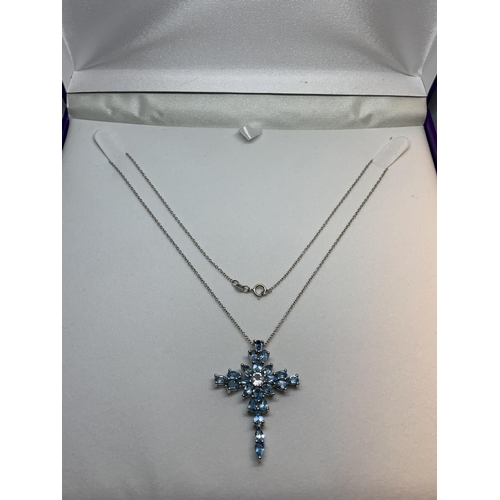 584 - A SILVER NECKLACE WITH A BLUESTONE CROSS IN A PRESENTATION BOX