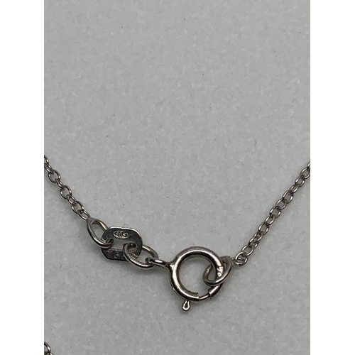 584 - A SILVER NECKLACE WITH A BLUESTONE CROSS IN A PRESENTATION BOX