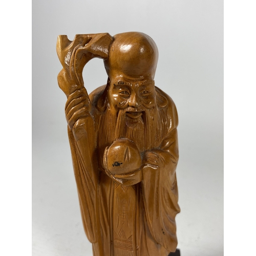 434 - A VINTAGE CHINESE CARVED WOODEN FIGURE OF AN IMMORTAL