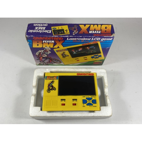 419 - A RETRO BOXED GRANDSTAND FLYER BMX LASERCOLOUR LCD GAME