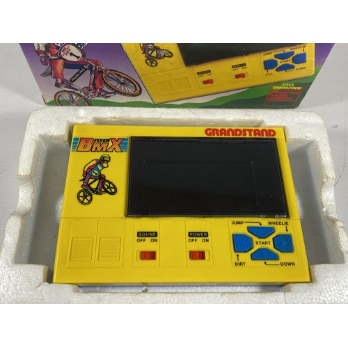 419 - A RETRO BOXED GRANDSTAND FLYER BMX LASERCOLOUR LCD GAME