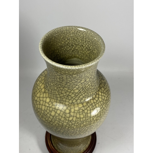 444 - A LARGE CHINESE CELADON CRACKLE GLAZE VASE ON WOODEN STAND, HEIGHT 38CM