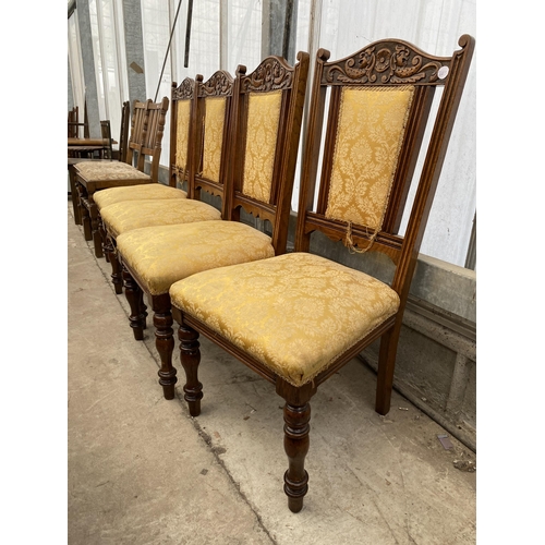 2533 - A SET OF FOUR SPRUNG AND UPHOLSTERED OAK LATE VICTORIAN DINING CHAIRS, ON TURNED FRONT LEGS