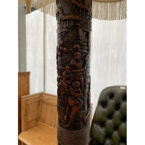 2580 - AN ORIENTAL HARDWOOD STANDARD LAMP COMPLETE WITH SHADE