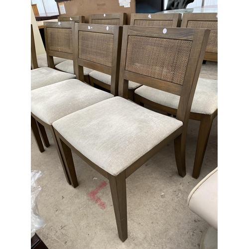 2596 - A SET OF EIGHT 'FIRST TIME' DINING CHAIRS WITH UPHOLSTERED SEATS AND DOUBLE CANE BACKS