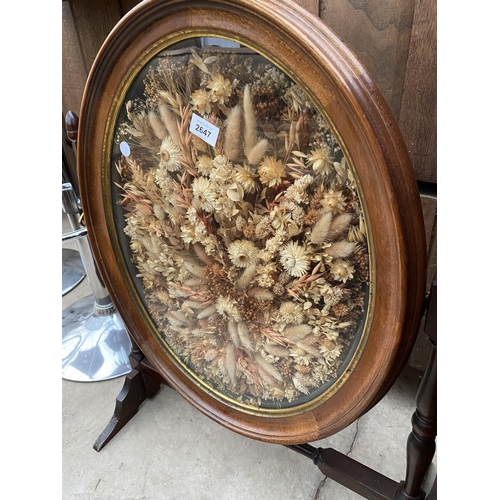 2647 - A FIRESCREEN, THE OVAL SWING FRAME DECORATED WITH DRIED FLOWERS