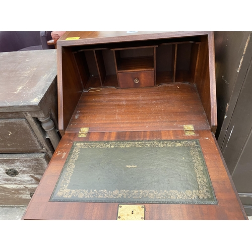 2693 - A REPRODUCTION MAHOGANY AND CROSSBANDED BUREAU WITH FOUR GRADUATED DRAWERS TO BASE, 21