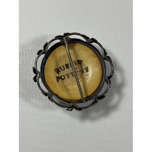 685 - A RUSKIN POTTERY AND HALLMARKED SILVER MOUNTED BROOCH