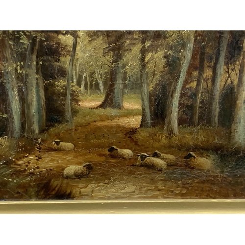 100 - A GILT FRAMED OIL PAINTING OF SHEEP IN A FOREST LANDSCAPE, SIGNED J.MORRIS, 47 X 68CM