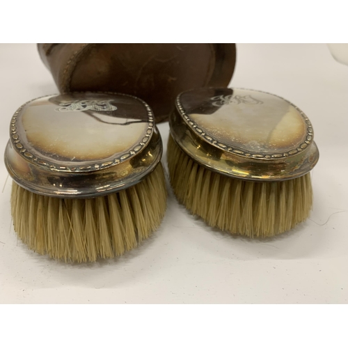 19 - A CASED PAIR OF HALLMARKED SILVER BACKED CLOTHES BRUSHES