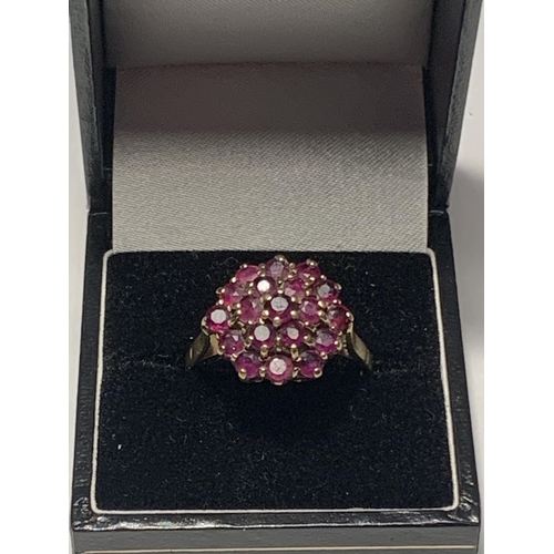 527 - A 9 CARAT GOLD RING WITH A CLUSTER OF NINETEEN RUBIES SIZE R/S IN A PRESENTATION BOX