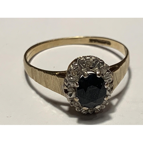 674 - A 9 CARAT GOLD RING WITH A CENTRE SAPPHIRE SURROUNDED BY DIAMONDS SIZE SIZE Q