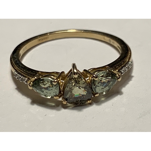 682 - A 9 CARAT GOLD RING WITH PERIDOTS AND DIAMONDS SIZE N/O