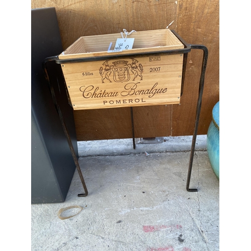 1600 - A MONOGRAMED WINE CRATE WITH A METAL TRIPOD STAND