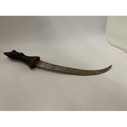 101 - A MIDDLE EASTERN STYLE DAGGER WITH CARVED FACE TO HANDLE