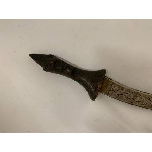 101 - A MIDDLE EASTERN STYLE DAGGER WITH CARVED FACE TO HANDLE