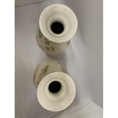 106 - A PAIR OF VINTAGE CROWN DUCAL BALUSTER VASES IN BLUSH IVORY WITHA BIRD DESIGN HEIGHT 31.5CM