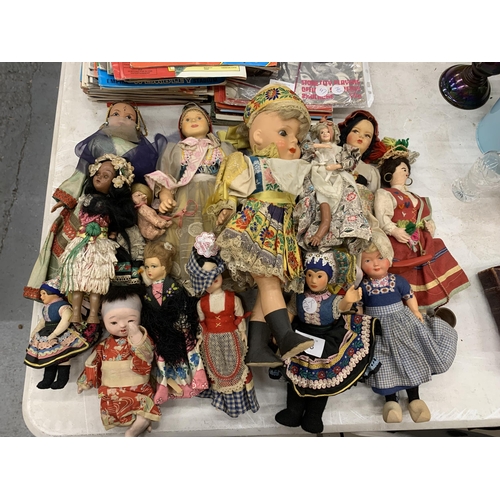 173 - A LARGE QUANTITY OF VINTAGE DOLLS IN TRADITIONAL COSTUME TO INCLUDE CERAMIC AND CLOTH