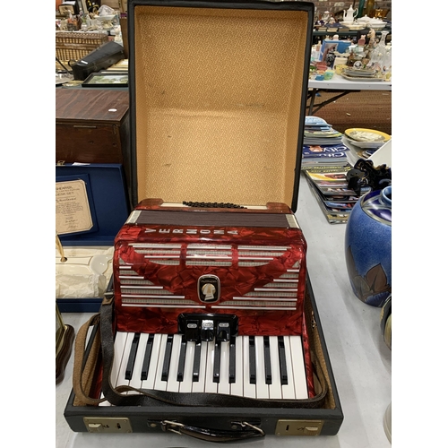 232 - A STUDENTS VERMONA WEITMEISTER RED ACCORDIAN IN A CASE