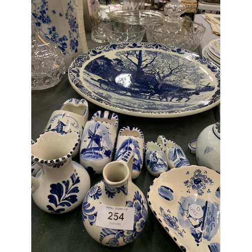 254 - A QUANTITY OF BLUE AND WHITE DELFT POTTERY TO INCLUDE A LARGE PLATE WITH HORSE AND CART DESIGN, CLOG... 