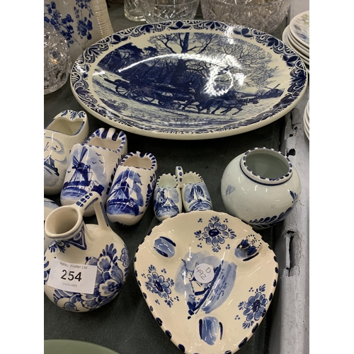 254 - A QUANTITY OF BLUE AND WHITE DELFT POTTERY TO INCLUDE A LARGE PLATE WITH HORSE AND CART DESIGN, CLOG... 