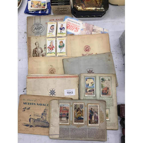 1043 - A QUANTITY OF CIGARETTE CARDS IN ALBUMS, LOOSE CARDS PLUS VINTAGE TINS, A JACKPOT BANK AND BRYANT AN... 