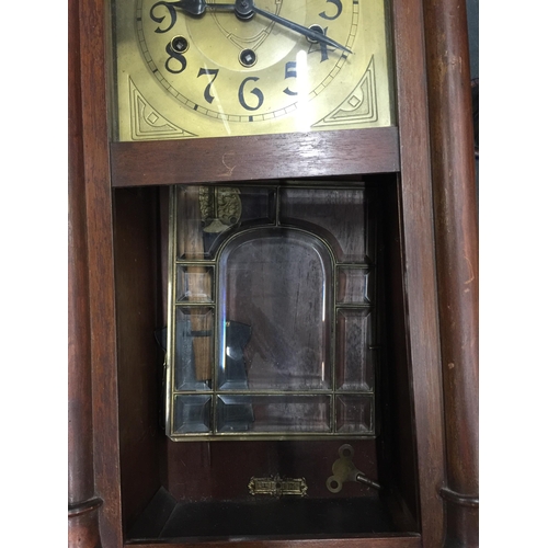 1058 - A MAHOGANY FRAMED WALL CLOCK WITH BEVELLED GLASS DOOR, PENDULUM AND KEY IN NEED OF SOME RESTORATION ... 