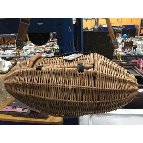 1061 - AN UNUSUAL OVOID SHAPED WICKER  PICNIC BASKET WITH ACCESSORIES