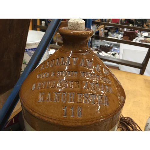 1083 - A LARGE WINE AND SPIRIT STONEWARE FLAGON WITH THE NAME E SULLIVAN & CO, MANCHESTER