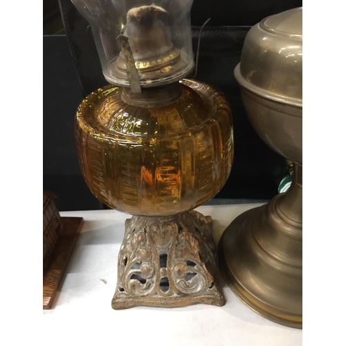 1090 - TWO VINTAGE OIL LAMPS ONE WITH A PIERCED BRASS BASE AND AMBER GLASS MIDDLE