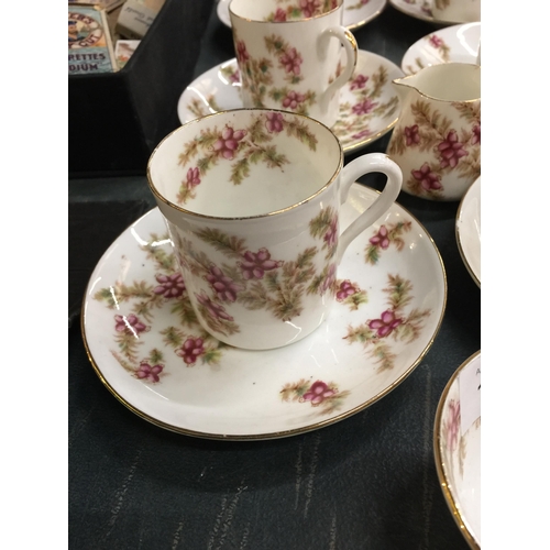 1103 - AN ANTIQUE TEA SET WITH FLORAL PATTERN TO INCLUDE CUPS, SAUCERS, A CREAM JUG AND SUGAR BOWL