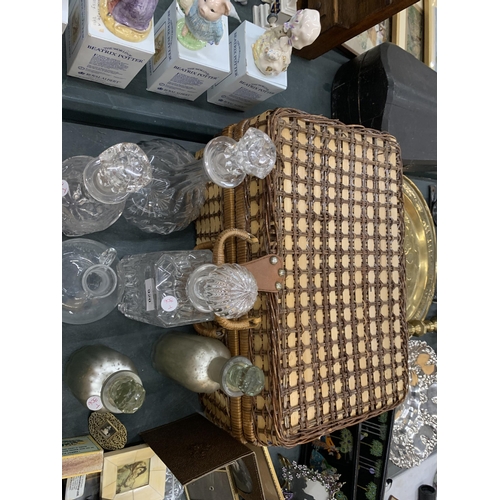 920 - A WICKER PICNIC BASKET PLUS A QUANTITY OF GLASS DECANTERS