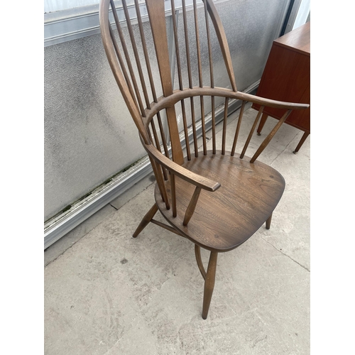 2503 - AN ERCOL ELM WINDSOR CHAIR WITH SPINDLE BACK AND SIDES, WITH CRINOLIN BOW