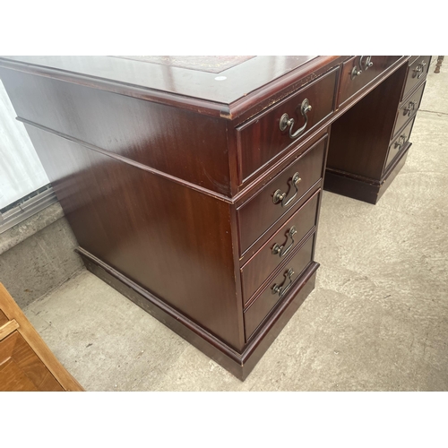 2507 - A MAHOGANY TWIN PEDESTAL DESK ENCLOSING EIGHT DRAWERS WITH INSET LEATHER TOP, 54X30